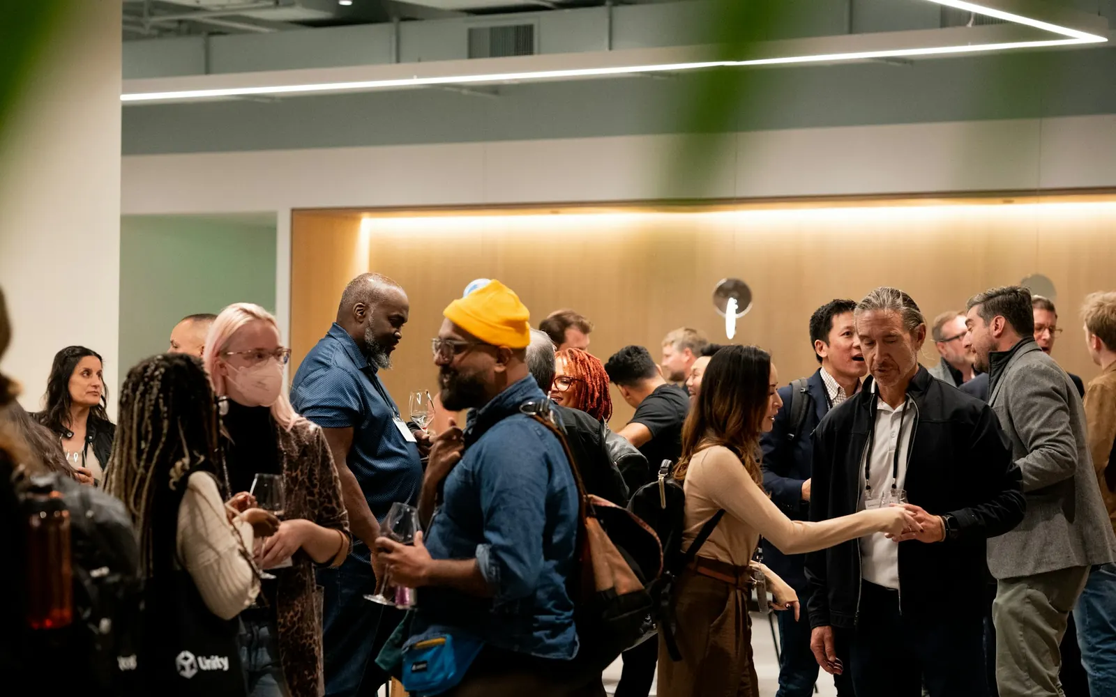 Participants qui échangent dans un salon professionnel, invités à transporter entre hôtels et lieu de l’événement